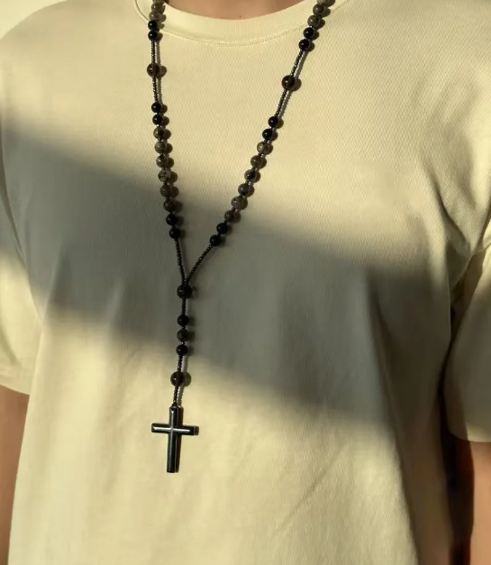 Long cross necklace worn with a casual outfit