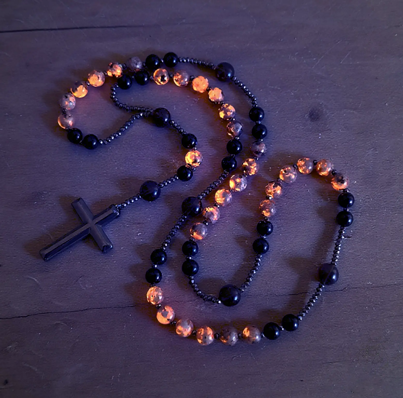 Natural obsidian and Yooperlite rosary necklace under UV light
