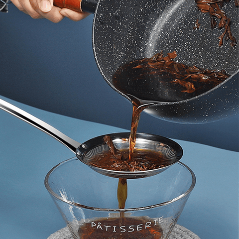 Fine mesh skimmer filtering tea leaves from liquid